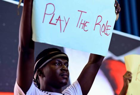 SOmeone holding up a placard with a message