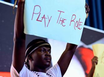 SOmeone holding up a placard with a message